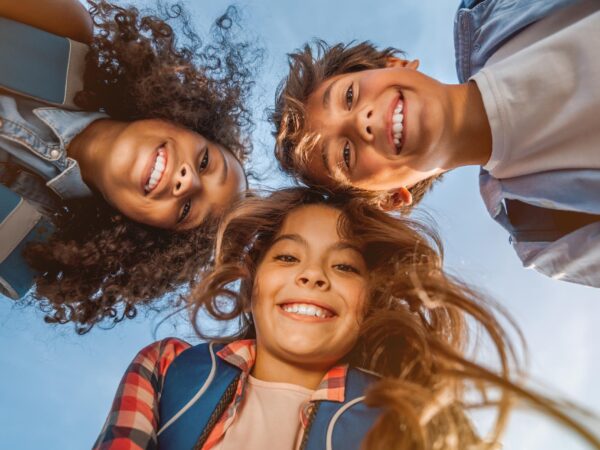 stock-photo-portrait-of-smiling-school-kids-standing-in-cecrle-at-school-yard-with-look-in-camera-1508727116