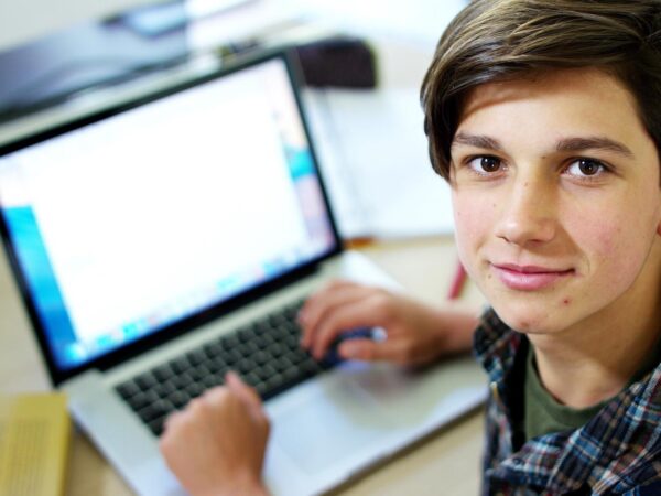 stock-photo-young-boy-student-studying-computer-and-is-happy-to-learn-new-things-557355136